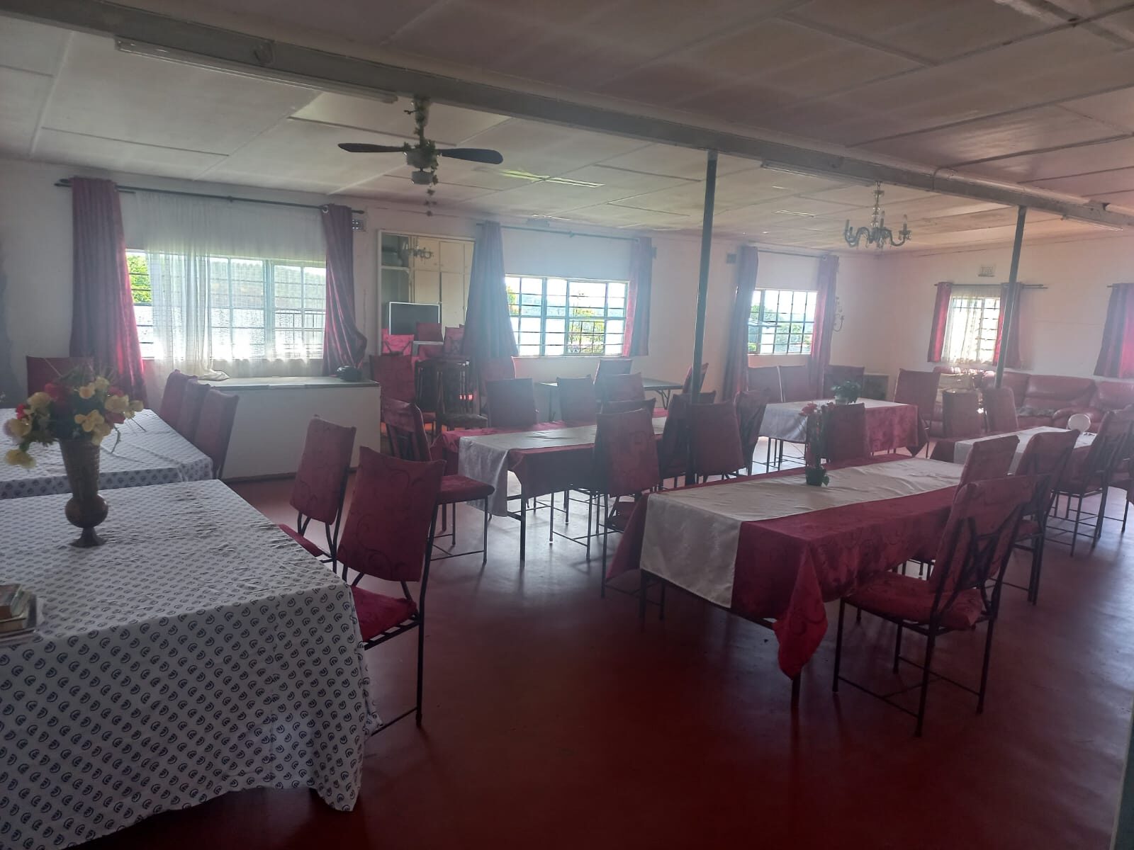Dining hall at The Word of God Care Centre in Port Shepstone, set with tables for lunch